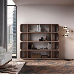 a living room with a book shelf next to a white couch and large window overlooking the city