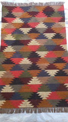 a multicolored rug with fringes on it