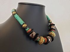 "Interesting and unique handcrafted tribal choker necklace...the jade colored pieces are known as interlocking prosser beads..there are numerous slices of shell and jasper stones amidst gold tone metal beads of various shapes and sizes..if you like jewelry that is unique and makes a statement, then you will just love this choker necklace..measures 17 1/2\" long with a hang length of 8 3/4\"..will ship insured us mail..etsy will send shipping / tracking info when shipped. www.etsy.com/shop/vintag Trade Bead Jewelry, Jade Color, Trade Beads, African Safari, Jasper Stone, Bead Jewelry, Choker Necklaces, Phoenix Az, Metal Beads