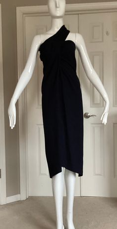 "This is a classic and iconic Romeo Gigli garment from 1992. It is black crepe wool and can be worn as a dress or a skirt.  Every Gigli collector loves this piece as it is so very wearable today either dressed  up or down. In one photo I show it with the matching long sleeve top (in a separate listing). He would have styled this garment with an iridescent silk neck scarf and an over sized cocoon coat. (See my other listings for such a jacket or coat).  This garment is Italian 42, USA 8 The fabric has stretch to it.  Measurements when worn as a skirt: Waist- 28\" Hips - 34\" Length - 40\" Measurements when worn as a dress: Bust - 34\" Waist - 28\" Hips - 37\" Length -39\"" Classic Wool Evening Dress, Formal Fitted Wool Midi Dress, Black Wool Dress For Formal Occasions, Black Wool Dress For Evening, Black Wool Evening Dress, Chic Sleeveless Wool Dress, Elegant Halter Dress For Workwear, Black Midi-length Halter Dress For Formal Occasions, Black Midi Halter Dress For Formal Occasions