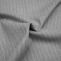 a close up view of a gray fabric with pinstripe pattern on it,