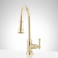 a kitchen faucet with two handles and nozzles on the side, against a white background