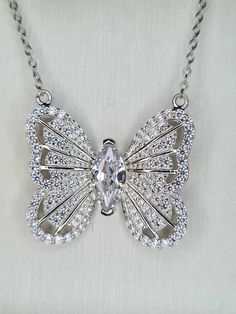 3.180ct. Cubic Zirconia Butterfly Necklace 925 sterling silver with Rhodium Overlay Hallmarked 925 solid sterling silver with a rhodium overlay  Chain size 20inches  Pendant size approx. 2cm from top wing to bottom wing Centre Stone White Cubic Zirconia Marquise 10x5mm Faceted Cut 1.500ct Wedding Jewellery Necklace, Butterfly Necklace, Wedding Necklace, Sterling Silber, Wedding Jewelry, Cubic Zirconia, Jewelry Necklaces, 925 Sterling Silver, Necklaces