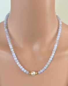 "A soft yet sparkly necklace of Blue Lace Agate cubes with a cultured White Pearl. The 5mm Agate cubes are faceted to catch the light from all angles which contrasts with the subtle radiant glow of the Pearl which is encased in gold-tone bead caps. This necklace is 17.25\" in length and has a 2\" gold-filled extender chain so you can wear it short or long. It has gold-filled beads and findings. NM Jewelry Design offers one-of-a-kind and limited edition jewelry. My creations are inspired by the cultures that traded along the ancient Silk Road. I am a Certified Gemologist and Accredited Jewelry Professional.   Please contact me for more information about the other necklaces shown in this listing." Elegant White Faceted Beaded Necklaces, Elegant Moonstone Jewelry With Faceted Beads, Rondelle Pearl Necklace With Faceted Beads For Gift, Gift Rondelle Pearl Necklace With Faceted Beads, Gift Rondelle Faceted Beads Pearl Necklace, Faceted Rondelle Pearl Necklace For Gift, Elegant Faceted Agate Beaded Necklaces, Elegant Chalcedony Gemstone Bead Necklaces, Elegant Beaded Chalcedony Jewelry