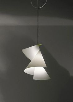 a white lamp hanging from a ceiling in a room with grey walls and flooring