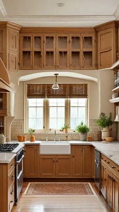 a kitchen filled with lots of wooden cabinets and counter top space next to a window