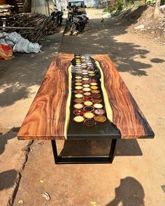 a table made out of wood with different types of cupcakes on it