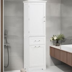 a tall white cabinet next to a sink and bathtub in a gray tiled bathroom