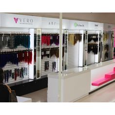 the interior of a clothing store with clothes on display