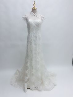 a white wedding dress on a mannequin