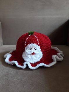 a crocheted santa claus hat sitting on top of a couch