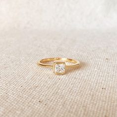 18k Gold Filled Stack-able Square Solitaire Ring features a 1.5 mm wide band with a single 5mm Square bezel Cubic Zircon Stone. Perfect to stack with other rings. * Metal: 18k Gold Filled * Available in sizes 5, 6, 7, and 8 * Weight: 1.8 grams * Band: 1.5mm wide * Stone: 5mm * Hypoallergenic jewelry * Handcrafted in Brazil Learn how to care for your jewelry with these easy instructions. Properly handling and caring for your ArtBossa jewelry is essential in maintaining its pristine condition. 1. Rings Metal, Pearl Love, Square Stone, Hypoallergenic Jewelry, Square Rings, Birthstone Charms, Pendant Rings, Gold Filled Jewelry, Pearl Ring