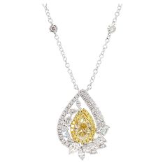 RareGemWorld's intriguing GIA certified diamond drop pendant. Mounted in a beautiful 18K Yellow and White Gold setting with a natural pear-cut yellow diamond. The yellow diamond is surrounded by round natural white diamond melee, natural pear-cut white diamonds, and natural marquise-cut white diamonds This pendant is guaranteed to impress and enhance your personal collection. Total Weight: 3.16cts Natural Pear-Cut Light Yellow Diamond Measurements: 9.08 x 5.70 x 3.65 mm Carat Weight: 1.35cts Clarity Grade: VS1 Natural Round White Diamonds Natural Pear Cut White Diamonds Natural Marquise Cut White Diamonds 18K Yellow/White Gold All diamonds are guaranteed natural International Shipments: Please note that customers are responsible for all import duties and taxes applicable to the country of Light Yellow Diamond, Diamond Drop Pendant, White Gold Set, Yellow Heart, Antique Pendant, Vintage Necklaces, Radiant Diamond, Modern Necklaces, Pear Diamond