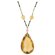 A fantastic and very unusual citrine necklace from the Late Art Deco (ca1930) era! This beautiful piece is comprised of a single large sized teardrop citrine that hangs from a 14kt yellow gold chain. The citrine teardrop has a faceted surface and lovely coloring and attaches to an ornate gold bail, which displays a feminine floral motif. The citrine stone hangs from a chain that is detailed with 6 graduating, faceted citrine beads which alternate with gold enameled bar links. The enameled links are detailed with black green and burnt orange stripes. These colors look wonderful next to the gold links! The necklace has two clasps: one at the back, and one connecting the citrine stone, which makes it possible to use the chain with another pendant. One of the clasps is marked "14K". It's a fab Briolette Necklace, Late Art, Citrine Pendant, Citrine Beads, Citrine Necklace, Gold Long Necklace, Long Chain Necklace, Citrine Stone, Deco Jewelry