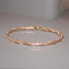 A pretty little bracelet of four strands of 14kt gold filled--three plain square wires, overwrapped with one strand of twist wire. Charming and feminine, and perfect to wear every day. Stackable with so many of my other wirewrapped bracelets! What a sweet graduation gift for a special young lady! Or just as nice for a birthday, Christmas, or Hanukkah. Of course, you can always treat yourself as well! The sturdy built-in hook and eye clasp is easy to get on and off by yourself. Choose your size f Gold Wire Wrapped 14k Gold-filled Bracelets, Gold Wire Wrapped Bracelets In 14k Gold Filled, Wire Wrapped 14k Gold Filled Bracelets, Dainty Hand Wrapped Gold Bracelet, Gold Wire Wrapped Bracelets, Elegant 14k Gold Filled Hand-wrapped Bracelets, Minimalist Gold Hand Wrapped Bracelets, Elegant Handmade Gold Wrap Bracelet, Elegant Hand Wrapped 14k Gold Filled Bracelets