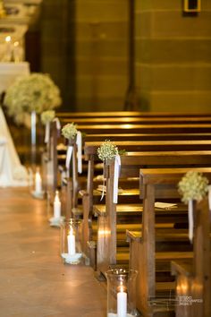 rows of pews decorated with flowers and candles