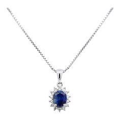 Item Details: - Type: Drop Pendant Necklace  - Metal: 18K White Gold  - Weight: 1.05 Grams (pendant only) - Setting: Prong, Halo ______________________________  Center Stone Details: - Type: Natural Sapphire  - Carat: 1.20  - Cut: Oval  - Color: Blue  - Measurements: 6.5 X 5 MM  ______________________________  Side Stone Details:  - Type: Natural Diamond  - Cut: Round  - Color: G-H - Clarity: SI1-SI2 - Quantity: 14  ______________________________  Dazzling modern drop pendant necklace, featuring a 1.20 carat natural oval cut Sapphire radiating a deep royal blue. This center stone is matched with 14 piece round-cut diamond halo in a star motif pendant made of 18K white gold. Set with an open back to allow for the center stone's natural color to be on full display.   The default order comes Formal Blue Oval Diamond Necklace, Blue Oval Diamond Necklace Fine Jewelry, Blue Oval Diamond Necklace In Fine Jewelry Style, Oval Sapphire Diamond Necklace, Luxury Oval Sapphire Necklace, Luxury Sapphire Oval Necklace, Oval Blue Diamond Necklaces, Blue Oval Diamond Necklaces, Oval Halo Setting Necklace For Formal Occasions