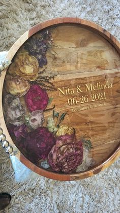 a wooden wine barrel with flowers painted on the side and personalized to someone's wedding date