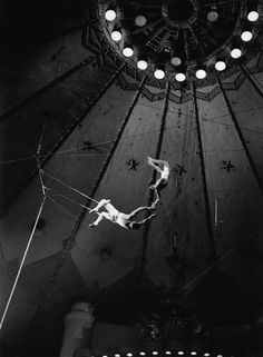 a man is suspended in the air on a tightrope between two poles and lights