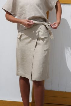 This wrap skirt VITA offers both comfort and style. This lightweight and casual skirt has a relaxed yet flattering look, and its beautiful wrinkles give it character without the need for ironing. Wear as loose or as tight as desired - customize this lovely wrap skirt depending on how you feel on the day! It is perfect for the city hot summer as well as wearing the wrap skirt on top of a bikini. DETAILS: Handmade from 100% pre-washed and softened linen 100% European linen - highest quality organic and OEKO-Tex® certified, medium weight linen in 205 g/m2 density. Designed with belt comfortable for any body shape Straight silhouette wrap skirt Practical two sides pockets Wrap around SIZE: S-M-L-XL-XXL COLOUR: Pale Sand Other Colours available CARE INFO: Wash up to 30oC (86oF) Tumble dry low h Beautiful Wrinkles, Linen Wrap Skirt, Linen Midi Skirt, Midi Skirt With Pockets, Skirt With Pockets, European Linens, Casual Skirt, Style Expert, Linen Top