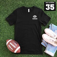 Football graphic with number inside, and name underneath along with number on the back on the t-shirt. Child's name and football numbers are customizable! Graphic color varies on t-shirts. Customization:Message us with your order number and the player's name and number. Custom orders take 1-2 weeks. Adult Sizes S-XXL (unisex sizing) For Custom Adult & Youth Sweatshirt click here to view.Bella + Canvas4.2 oz. Airlume combed and ring-spun cottonPre-shrunkFor a more relaxed fit, size up! Football Number Shirts, Black Number Print T-shirt For Game Day, Number Print T-shirt For Game Day During Football Season, Black Sports T-shirt With Number Print, Black T-shirt With Name Print For Football Season, Football Numbers, Football Names, Diy Halloween Projects, Camp Style