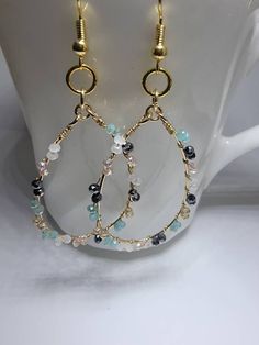 These delicate beaded wire hoops are attached to 18k gold plated brass ear wires that are nickel free. The tiny faceted glass beads are black, champagne, white, and minty green. This color combo lends itself to multiple oufit pairings making this a versatile accessory. Hoop Bead Earrings, Earrings Making, Minty Green, Beaded Jewellery, Beads Earrings, Wire Work Jewelry, Work Jewelry, Handmade Wire Jewelry, Ear Rings