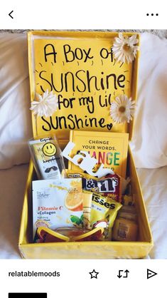 a box of sunshine for my lil sunshineie is on the bed with its contents