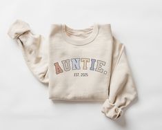 Auntie Est. 2025 Sweatshirt, Auntie est 2025 Crewneck, Aunt Gift, Aunt Sweater, Auntie Gifts, Aunt Announcement Gift, Aunt Top 2025 This crewneck sweatshirt is pure comfort. Made from a soft cotton/poly blend with no itchy side seams, this is sure to become a staple. SIZE AND FIT: Your sweatshirt design will be printed on a high-quality, soft and comfortable unisex sweatshirt. Sizes run true to size, which takes the guesswork out of ordering; if you like your sweatshirts loose or oversized, you Aunt Announcement, Aunt Sweater, Auntie Sweatshirt, Auntie Gifts, Cute Sweatshirts, Aunt Gifts, Oct 11, Sweatshirt Designs, Women's Style