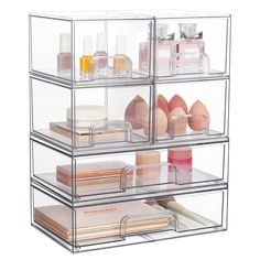 three tiered clear acrylic storage unit with cosmetics and beauty products in it