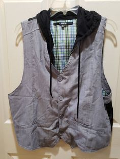 This reversible vest can be formal in the colors of grey, black or in the form of casual with a green blue white plaid vase. It has grey bottom for a formal look or a zipper for a casual look. Great piece. This vest is an xl size, mark carbon, 65 % polyester and 35 % rayon. Note:  If for male it may fit a large size and for female it will fit  an XL size is my opinion. Mens Formal Vest, Formal Vest, Plaid Vest, Reversible Vest, Mens Vests, Mens Formal, Vest Outfits, Formal Looks, White Plaid