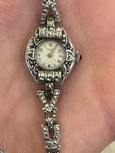 "Here is a beautiful Rotary vintage Ladies Marcasite Art Deco style 17' Jewels Mechanical dress WatchSwiss Made. I think the metal is rhodium plated. The watch itself is very Art Deco in style but was probably made in the 1950-60s. It is in great vintage condition and is complete with a safety chain. It measures an approximate length of just under 7\"." Luxury Antique Watch Accessories For Formal Occasion, Silver Art Deco Watches For Weddings, Art Deco Silver Wedding Watches, Vintage Hallmarked Jewelry For Evening, Hallmarked Vintage Jewelry For Evening, Vintage Silver Metal Jewelry And Watches, Antique Silver Diamond Watch, Antique Silver Watch For Wedding, Formal Art Deco Silver Diamond Watch