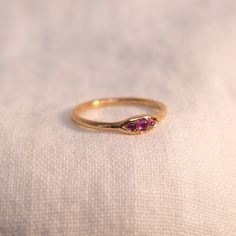 One of our favorite stone combinations. Three vivacious fuchsia-toned Vietnamese Rubys sit in 14k gold. The stones are set in a graceful and dainty setting, and sit atop a slim 14k band. It's hard not to fall head over heels for this charming piece! Materials: 14k Gold, 3 Vietnamese Rubys Trio Ring, Ring Ruby, Jewelry Lookbook, Head Over Heels, Ruby Ring, It's Hard, Ruby, Lookbook, Ships