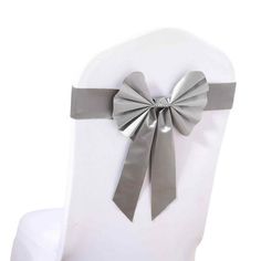 a white chair with a silver bow on it