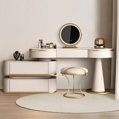 a white and gold vanity with stools in front of it on a wooden floor