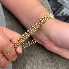 This 433 Gold Bead Bracelet Stack is made of 14K gold filled balls strung on a strong elastic cord. This makes the bracelets both stretchy and durable. These beaded bracelet stacks won't tarnish, making them perfect for everyday wear. Leave them on in the shower, pool, or ocean without a worry in the world. Enjoy a touch of luxury with these stacking bracelets that stands the test of time. This gold bracelet stack has (1) 4MM bracelet and (2) 3MM bracelets. Make sure to also select the appropria Flexible Gold Beaded Bracelets, Flexible Gold Jewelry With Round Beads, Gold Beaded Bracelets With Ball Chain, Adjustable Ball Chain Beaded Bracelets As Gifts, Adjustable Ball Chain Beaded Bracelet For Gift, Adjustable Beaded Bracelet With Ball Chain For Gifts, Gold Bracelet Stack, Bead Bracelet Stack, Gold Bead Bracelet