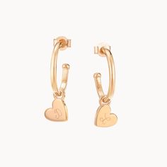 Our Personalized Heart Hoop Earrings feature delicate heart-shaped pendants that gently hang from the hoop size of your choice.18K Champagne Gold Plated or 925 Sterling SilverEarring charm size: Approx. 0.3Hoop size: Mini - 0.5 diameter. Midi - 0.7 diameter. Maxi - 1.4 diameter.Hand-engraved in our Paris workshopSent with love in a complimentary gift boxAny slight variations in lettering depth, spacing and alignment from the examples shown are part of the aesthetic and originality of the piece Anniversary Heart Charm Dangle Hoop Earrings, Small Hoop Earrings With Heart Charm For Anniversary, Anniversary Dangle Hoop Earrings With Heart Charm, Dainty Heart Charm Hoop Earrings, Anniversary Small Hoop Earrings With Heart Charm, Dainty Sterling Silver Hoop Earrings With Heart Charm, Anniversary Small Hoop Huggie Earrings With Heart Charm, Dainty Heart Charm Huggie Earrings For Anniversary, Valentine's Day Small Hoop Earrings With Heart Charm