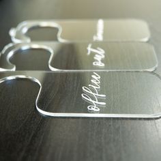 three glass coasters with the words happy new year written in white ink on them