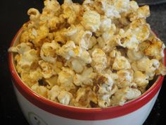 a red and white bowl filled with popcorn