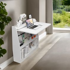 a laptop computer sitting on top of a white desk next to a plant in a living room