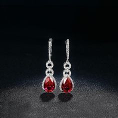 Features These Fashion Pear Ruby Sterling Silver Drop Halo Earrings feature a classic and stylish design style suitable for any occasion. Made all by hand! It truly deserves a spot in every jewelry collection. Beautifully crafted, this style is sure to become a treasured keepsake. Each Ruby used for our jewelry was carefully checked and verified by our experts, so that they meet the highest standard. Providing high-quality items is our most important goal, which starts with selecting the best st Ruby Earrings Silver, Ruby Jewelry Silver, Red And Silver Earrings, Ruby Jewelry Earrings, Red Ruby Earrings, Ruby Earring, Diamond Earrings Wedding, Prom Inspo, Silver Diamond Earrings