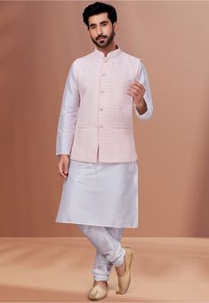 Art Dupion Silk Kurta in White This Readymade attire is Enhanced with Buttons, Pocket, Thread and Chikankari Work. Crafted in Chinese Collar Neck and Full Sleeve Available with an Art Dupion Silk Churidar in White and a Faux Georgette Nehru Jacket in Baby Pink Do note: Footwear shown in the image is for presentation purposes only. Half to one inch may vary in measurement. (Slight variation in actual color vs. image is possible) Spring Traditional Long Sleeve Wear With Dori Work, Pink Nehru Jacket With Zari Work For Spring, Spring Pink Nehru Jacket With Zari Work, Spring Wedding Pink Nehru Jacket, White Sherwani With Zari Work For Spring, Spring Long Sleeve Nehru Jacket With Cutdana, White Sherwani With Chikankari Embroidery For Spring, Spring White Sherwani With Chikankari Embroidery, Off White Traditional Wear For Spring Festive