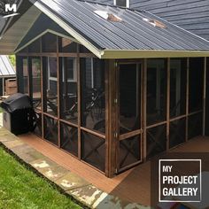 a small house with a metal roof and screened porch