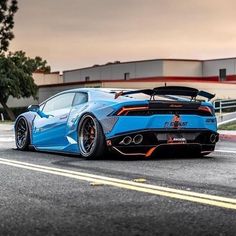 a blue sports car is parked on the street