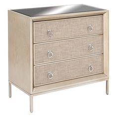 a white dresser with three drawers and silver handles