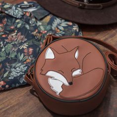 A small bag in a charming shape is the perfect accessory for nature and forest lovers. Green lining with a pocket inside. Adjustable strap. Composition: imitation leather, cotton (lining) Dimensions: diameter 19cm, depth 7.5cm Cute Brown Crossbody Shoulder Bag, Fox Bag, Purse Charms, The Fox, Messenger Bags, Cute Bag, Phone Bag, Small Bag, Leather Working