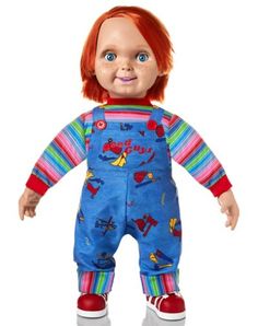 a doll with red hair and blue overalls is standing up in front of a white background