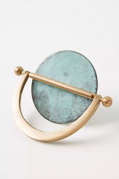 a gold and blue ring with a circular design on the front, sitting against a white background