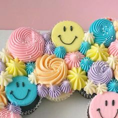 cupcakes are arranged in the shape of a smiley face