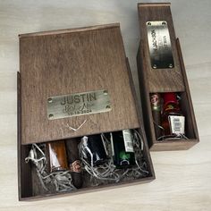 two wooden boxes with bottles in them on a table