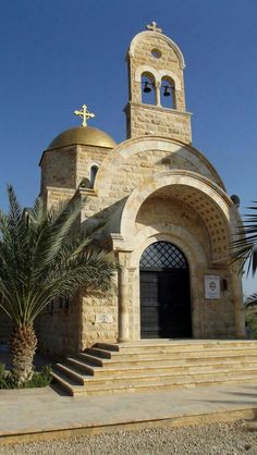 an old church with steps leading up to it and a palm tree in the foreground